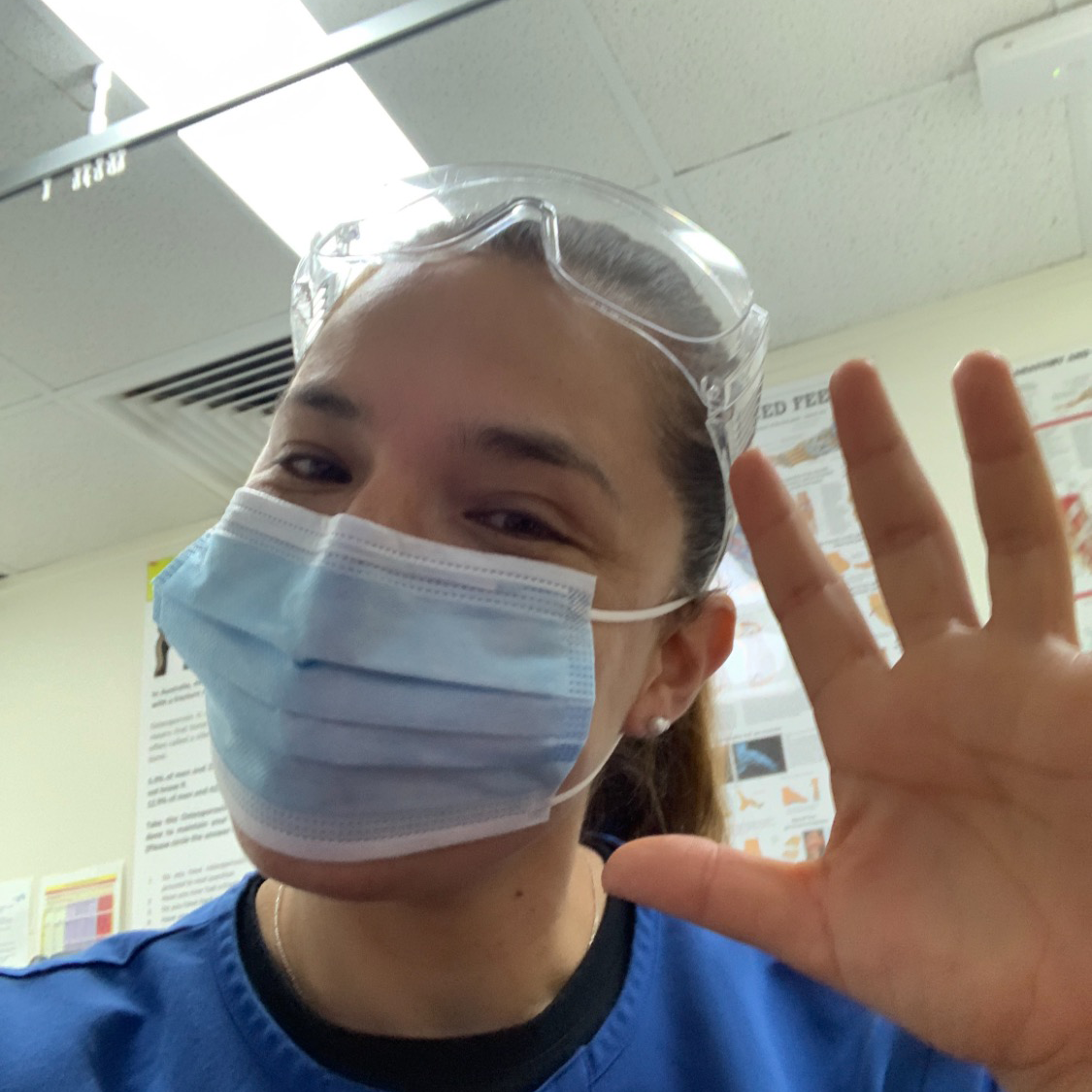 Angelica Berkeley waving and smiling in clinic